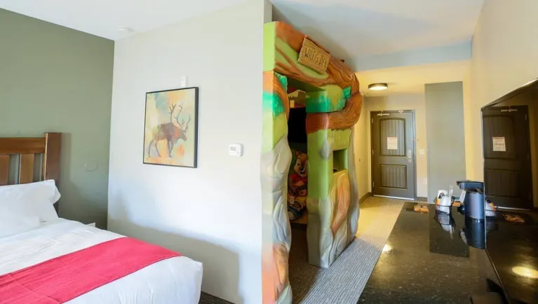 The bed and den in the Accessible Wolf Den Suite